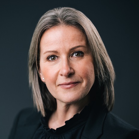 Portrait of a person with short gray hair and a black jacket.
