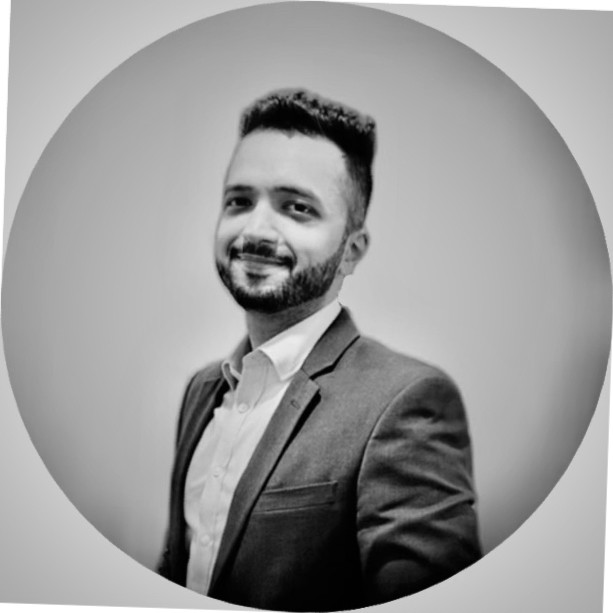 Person smiling in a suit against a circular background.