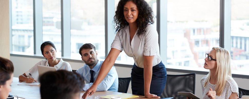 Person leads a meeting in a modern office setting.