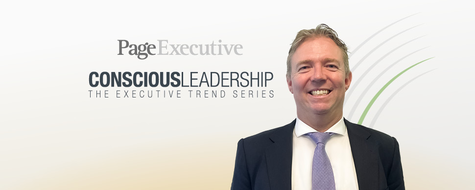Person smiling in formal attire with 'Conscious Leadership' text in background.