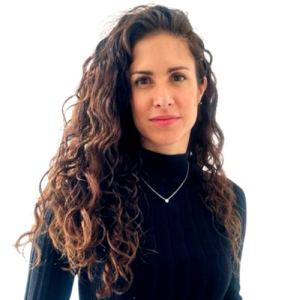 Person with long curly hair wearing a black turtleneck.