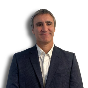 Portrait of a person wearing a suit and smiling at the camera.