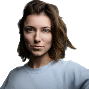 Portrait of a person with short brown hair in a blue shirt, looking directly at the camera.