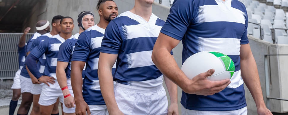 a group of rugby players entering the field