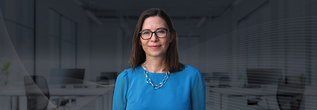Consultant Nina Buttle, smiling against an office background