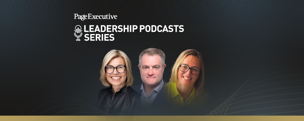 Group of three people in professional attire standing against a dark background with abstract golden lines.