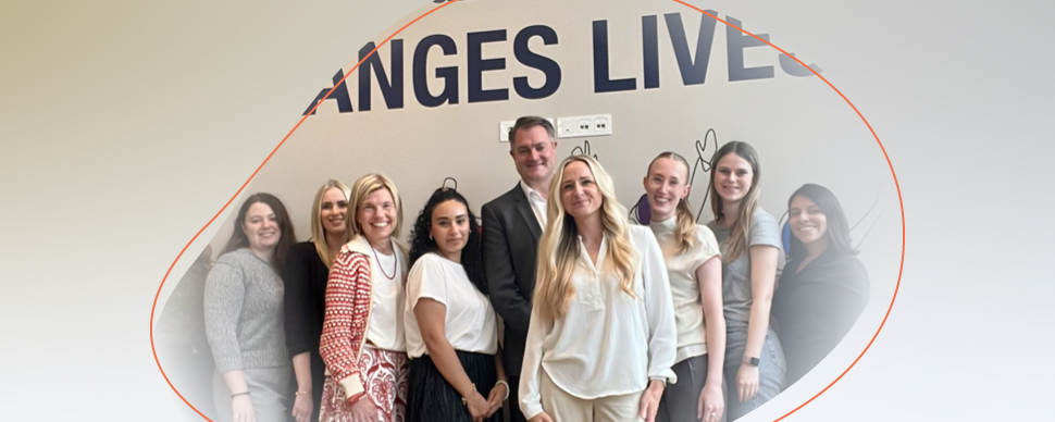 a group of university students standing and smiling