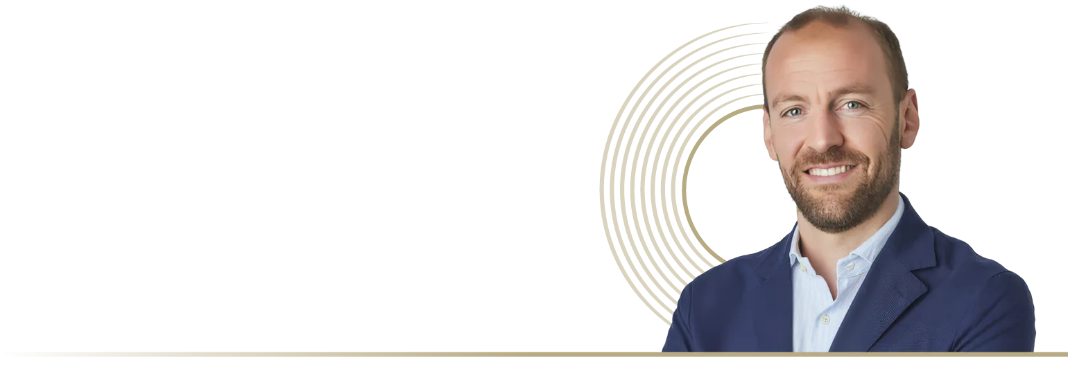 a man smiling with a circle shape in the background