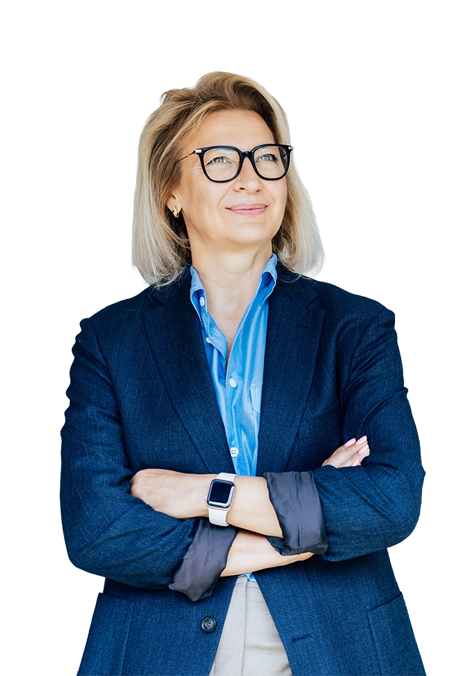 Professional portrait of a person wearing glasses and a blue blazer with arms crossed.