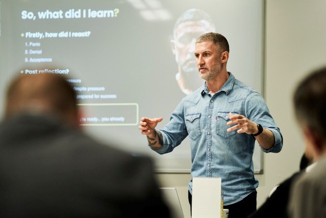 man giving a presentation in front of a group