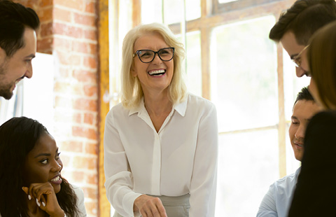 Group of colleagues having a cheerful discussion in a bright office.