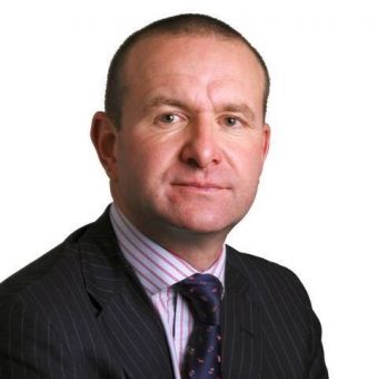 Person in a suit and tie against a white background.