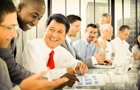 People in business attire having a meeting in a modern office.