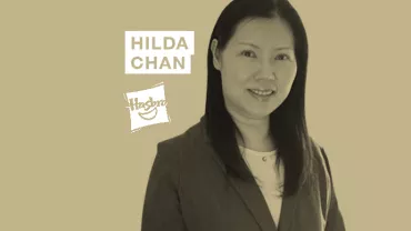 A person in professional attire with text 'Hilda Chan' and a logo in the background.