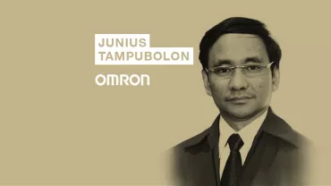 Person in suit with name Junius Tampubolon, Omron logo in backdrop.