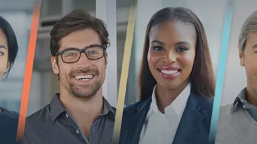 A diverse group of people smiling in a professional setting.