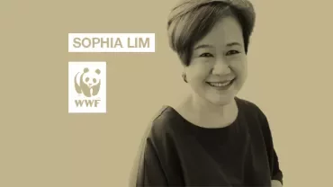 Person smiling in front of a beige background with WWF logo.