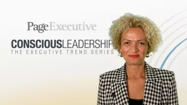 Person in houndstooth jacket smiling, with PageExecutive and Conscious Leadership text in background