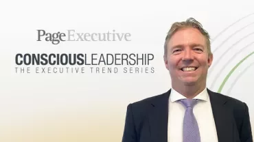 Person smiling in formal attire with 'Conscious Leadership' text in background.