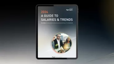 Cover of a 2024 salary and trends guide displayed on a tablet.