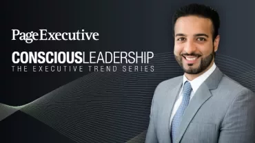 Man in suit smiling next to text 'Conscious Leadership' on dark background.