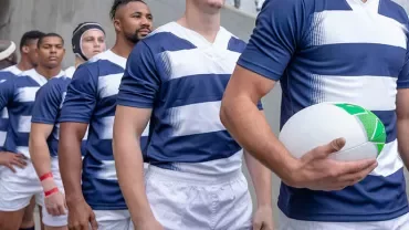 a group of rugby players entering the field