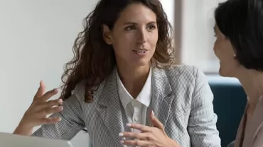 two women talking in the office