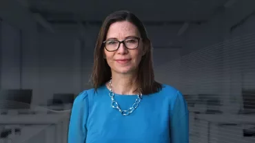 Consultant Nina Buttle, smiling against an office background