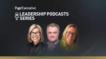 Group of three people in professional attire standing against a dark background with abstract golden lines.