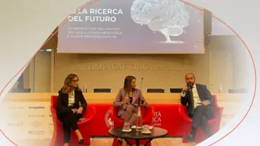 Three people giving a lecture at a university
