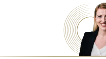 Margaux Perrier smiling in a dark background