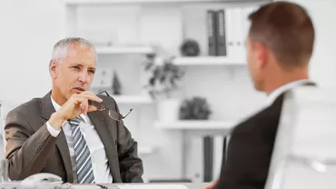 Two people having a discussion in an office setting.
