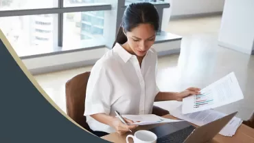 Person reviewing business documents at a desk.