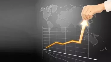 Hand lifting an arrow on a graph with a world map background.