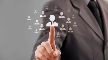 Businessperson selecting an individual icon on a digital screen
