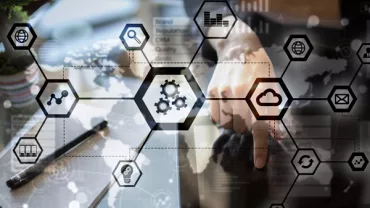 Person interacting with digital technology and cloud icons on a transparent screen.