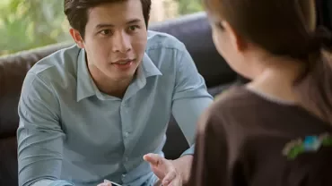 Two people having a focused conversation indoors.