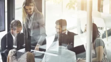 Group of people having a meeting in a bright office.
