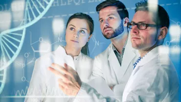 Three people in lab coats study digital DNA graphics.