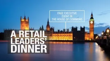 View of the illuminated Houses of Parliament at dusk with event text overlay.