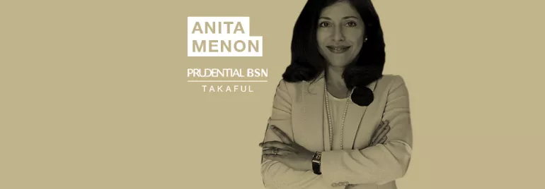 Person in a suit with arms crossed near the words Anita Menon Prudential BSN Takaful.