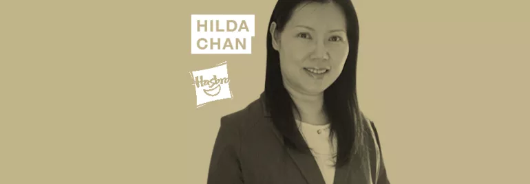 A person in professional attire with text 'Hilda Chan' and a logo in the background.