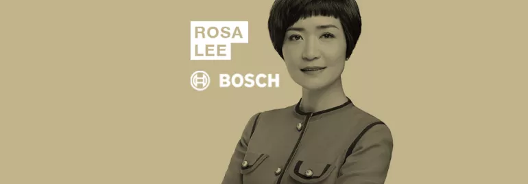 Person in business attire with a short hairstyle, next to the words 'Rosa Lee Bosch' on a beige background.