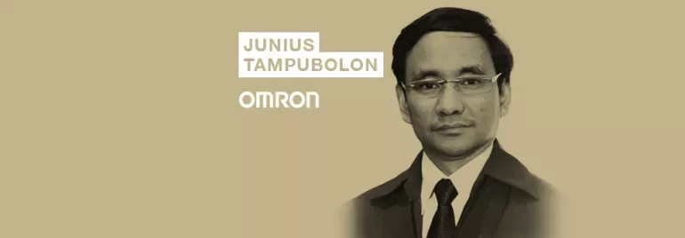 Person in suit with name Junius Tampubolon, Omron logo in backdrop.