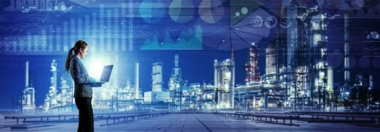 A person using a laptop with a digital data overlay and an industrial background.