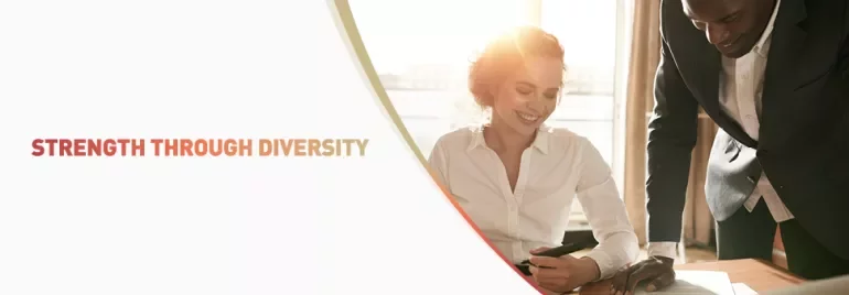 Two colleagues collaborating at a desk with the text 'Strength Through Diversity' displayed.