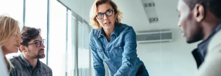 Group of people in a meeting room discussing a project.