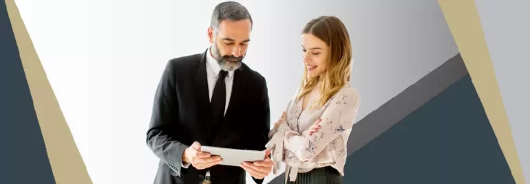 Two people reviewing information on a tablet.
