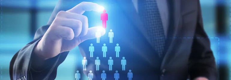 Businessperson selecting a red figure among blue figures, symbolizing decision-making or leadership.