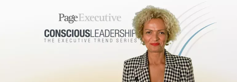Person in houndstooth jacket smiling, with PageExecutive and Conscious Leadership text in background